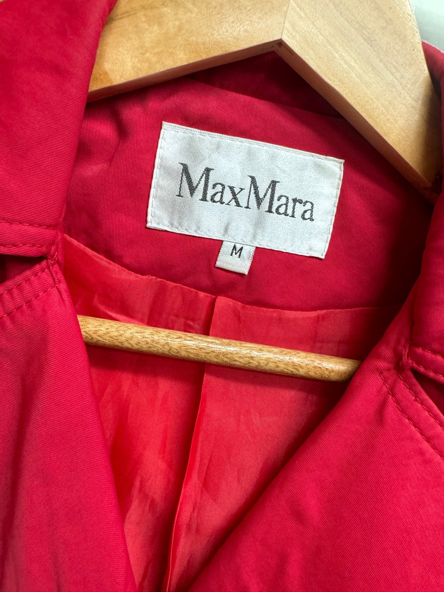 Close-up of the label inside a Vintage MaxMara red double-breasted trench coat.