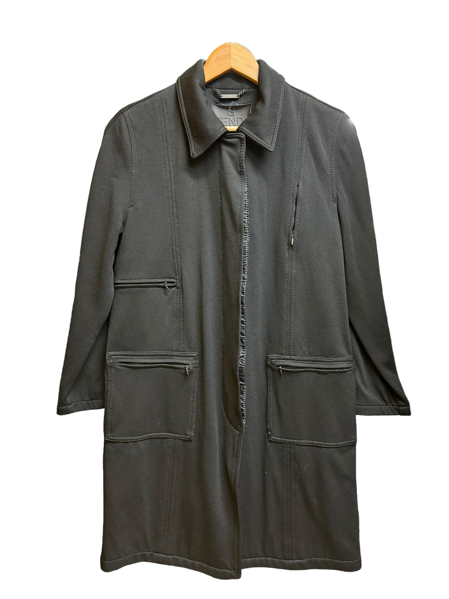 Vintage Fendi black long coat with vertical linings, front pockets, and zipper details, approximately UK10 fit, displayed on a hanger.